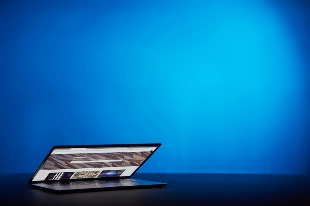 ai website designer header photo with laptop and blue background