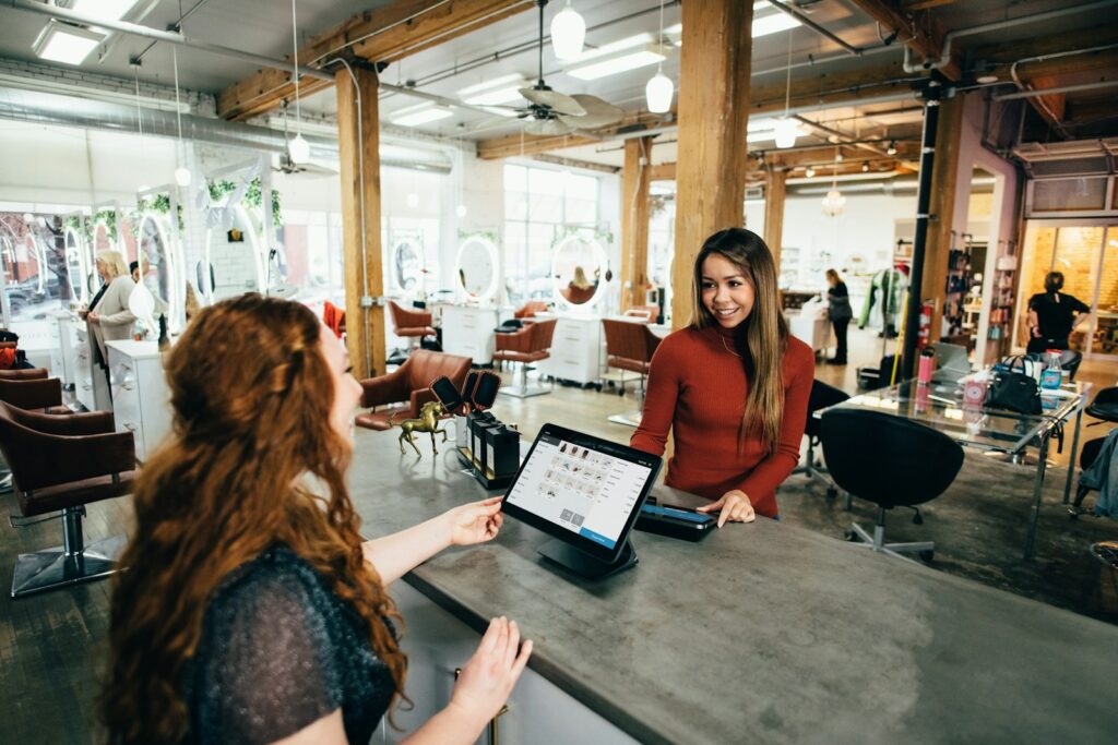two women on table with laptop for ai website builder header image